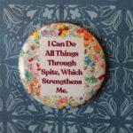 Photo of a button reading "I can do all things through spite, which strengthens me"