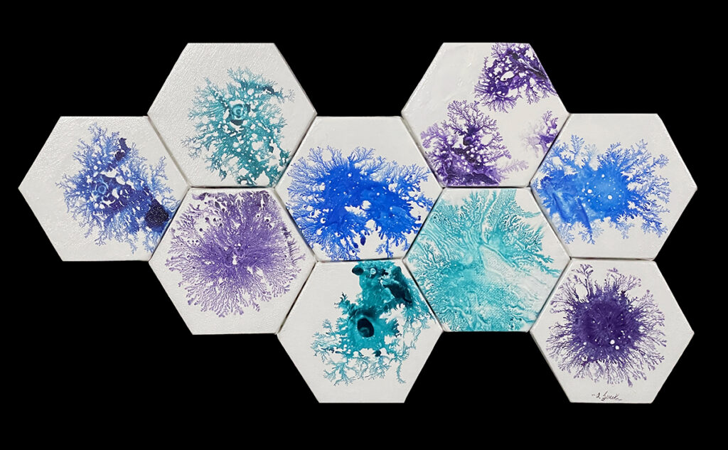 Nine white hexagonal canvases arranged in a cluster, painted with branching abstract designs in blue, purple and turquoise.